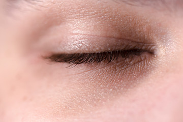 Closed human eye close-up.