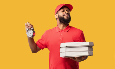 Courier Delivering Pizza Holding Boxes And Clock On Yellow Background