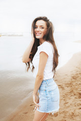 Young beautiful happy woman is relaxing on beach