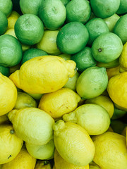 ripe green and yellow lemons for eating as a background