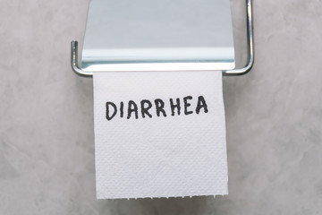 Toilet paper with text diarrhea in wc. Concept of personal hygiene. Fast food Concept