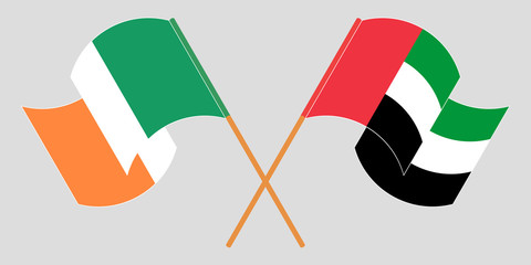 Crossed and waving flags of Ireland and the United Arab Emirates