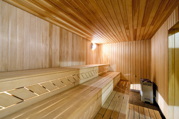Traditional Finnish bath - sauna. Sauna wooden room with wooden benches and a stone stove