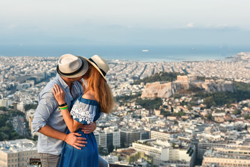 
A couple of tourists in love kissing on Mount Lycavitos in Athens at dawn. The best panorama of...
