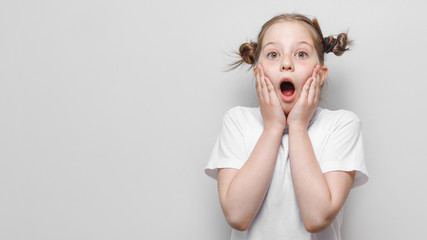 surprised little girl on a white background