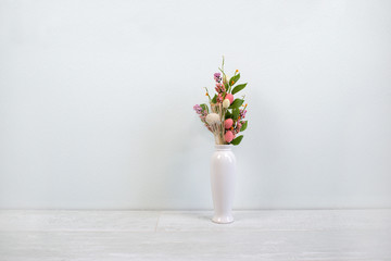 Interior decoration of a house, flowers and white vase on white wood background. Modern interior. Minimalism style.