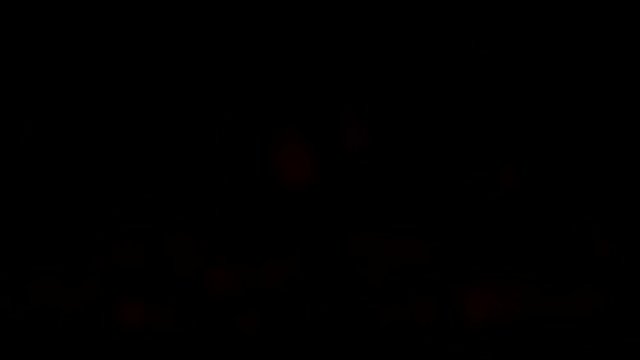 Blur forks of flame in darkness. Electrical fireplace. Black background. 4K Ultra HD