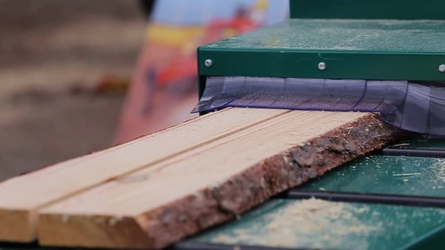 Cutting wood at a wood factory. A sawmill is a facility where logs are cut into lumber. Sawmill machine saws the tree trunk on the plank boards