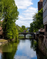 Fototapeta na wymiar Nuremberg, Bavaria / Germany - May 06, 2020. View from the Museumsbrücke which is a sandstone arch bridge over the Pegnitz river.