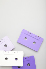 Old colorful cassettes on a grey background. Music day