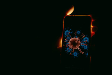 Coronavirus on a smartphone screen in woman hands lignten with scary light on black background