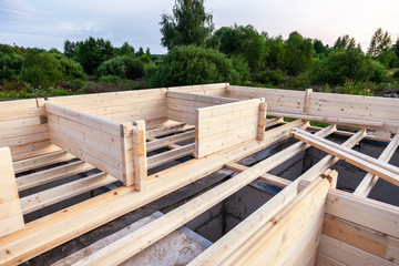 Construction of a wooden house on the stone foundation