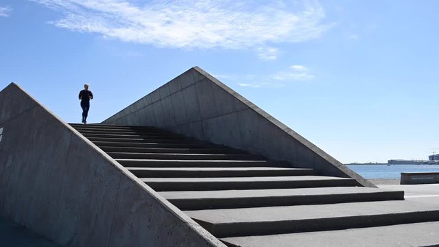 Attractive young woman, running down stairs in slow motion, stock footage by Brian Holm Nielsen 3