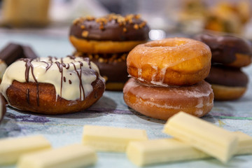 donuts in different glazes with chocolate, sprinkles and stripes