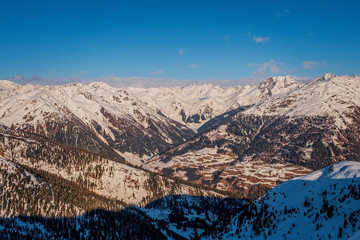 Obraz na płótnie Canvas January 2020 Sillian, Austria: snowy ski run on the foreground, blue sky on the background