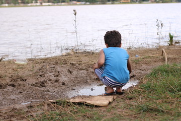 little boy sitting on the beach