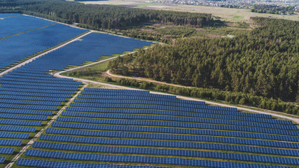 aerial view of solar panels on green lawn. drone shot, bird's eye...