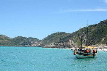 Naklejka na ściany i meble Blue sea in Brazilian tropical paradise, Arraial do Cabo. With boats in the background