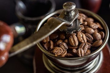 Coffee beans in a manual coffee grinder.