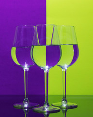 Purple and Yellow reflected into three wine glasses