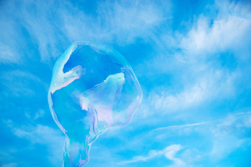 Soap sparkling bubble against a blue sky.