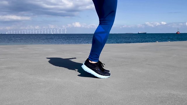 Attractive, fit, young woman jumping rope in slow motion, stock footage by Brian Holm Nielsen