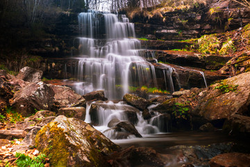 Fototapeta na wymiar Waterfall in a forest on mountain. Called Tupavica waterfall on old mountain (stara planina) near the village Dojkinci in Serbia