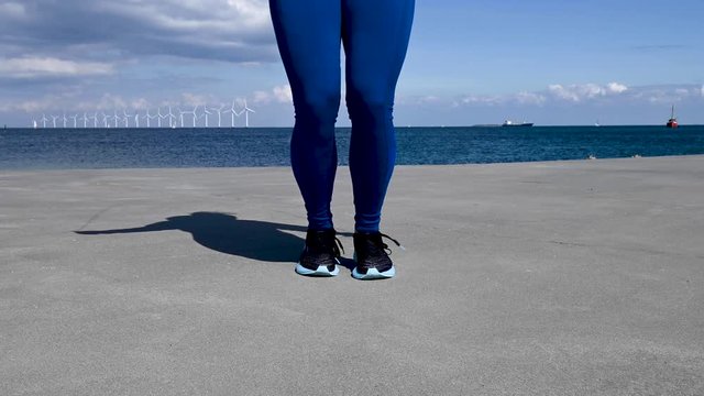 Attractive, fit, young woman jumping rope in slow motion, stock footage by Brian Holm Nielsen