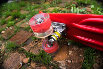 red children's skateboard in the grass
