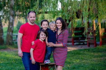 Spring portrait of happy family in nature on sunset