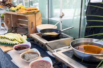 Candy bar food buffet by the pool, during hotel brunch, catering ,Chef live pancakes cooking station