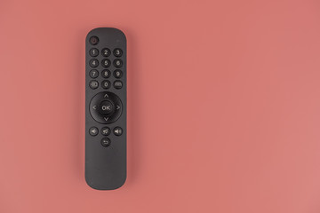 Black TV remote in hands