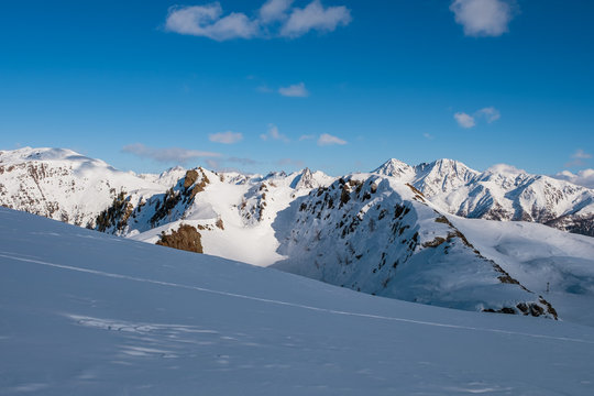 January 2020 Sillian, Austria: snowy ski run on the foreground, blue sky on the background