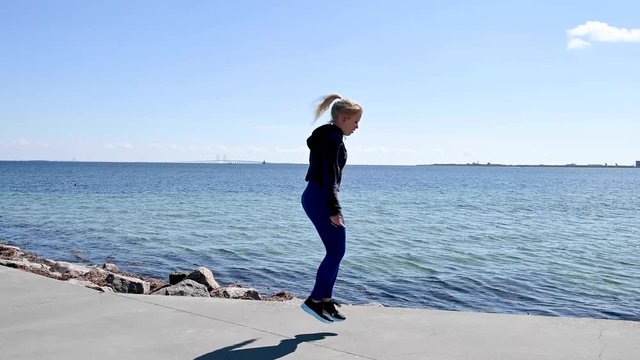 Attractive, fit, young woman jumping rope, stock footage by Brian Holm Nielsen