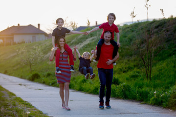 Spring portrait of happy family in nature on sunset