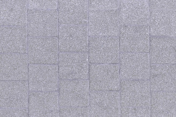 Photo of a stone road tile. Gray background for sites and layouts