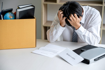 Images of packing up all his personal belongings and files into a brown cardboard box, Businessman...