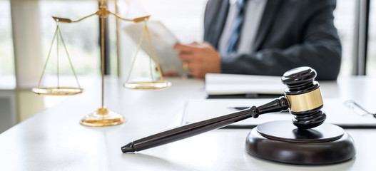 Counselor in suit or lawyer working on a documents in courtroom