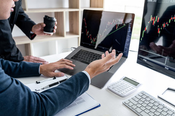 Business team partner working with computer, laptop, discussion and analyzing graph stock market trading with stock chart data planning, financial and investment concept