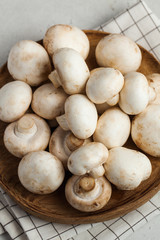 Fresh porcini mushrooms on a wooden plate close-up. Food for vegetarians. copy space. Ingredients