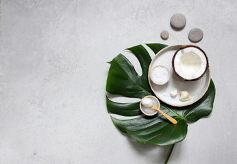Spa setting with monstera leaves top View. Natural products for Spa and massage with coconut.