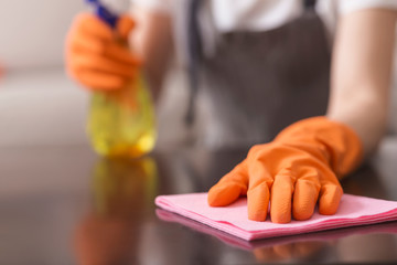 Unrecognizable Woman Wiping Dust From Table With Rag And Sprayer Detergent