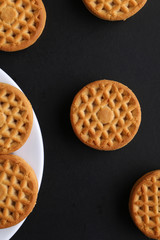 cookie close-up on a plate on a table. vertical view from above
