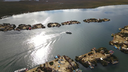 Lake Titicaca in Puno in Peru, view from drone and floating islands of the Uros people in the background