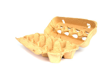 Empty grass-based egg box made from a mixture of ryegrass, hay and recycled paper isolated on white background with copyspace, mockup