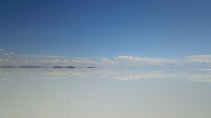 Salar de Uyuni, Salt desert in Bolivia, seen with drone and Andes in the background