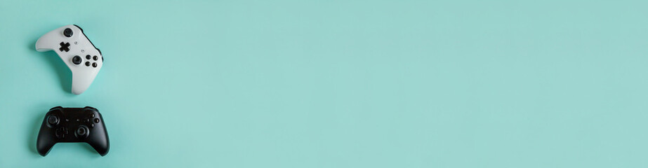 White and black two joystick gamepad, game console isolated on pastel blue colourful trendy background. Computer gaming competition videogame control confrontation concept. Cyberspace symbol. Banner © Юлия Завалишина