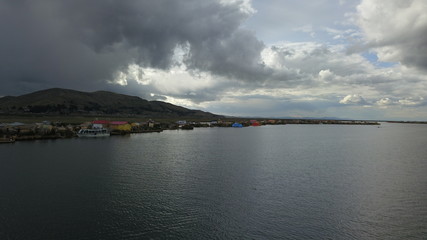 Lake Titicaca in Puno in Peru, view from drone and floating islands of the Uros people in the background