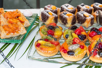 Candy bar food buffet by the pool, during hotel brunch, catering in the garden, food bloggers event
