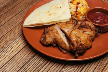 chicken skewers with salad and sauce on a background of wood. BBQ chicken. Healthy food. Healthy food. Flat lay. Top view